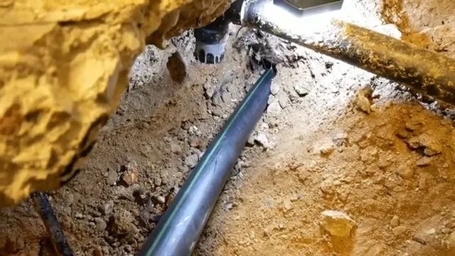 Underground Black Sewer Line In Soil shown for Sewer Line Repair & Replacement in Dallas, GA in Dallas, Georgia.