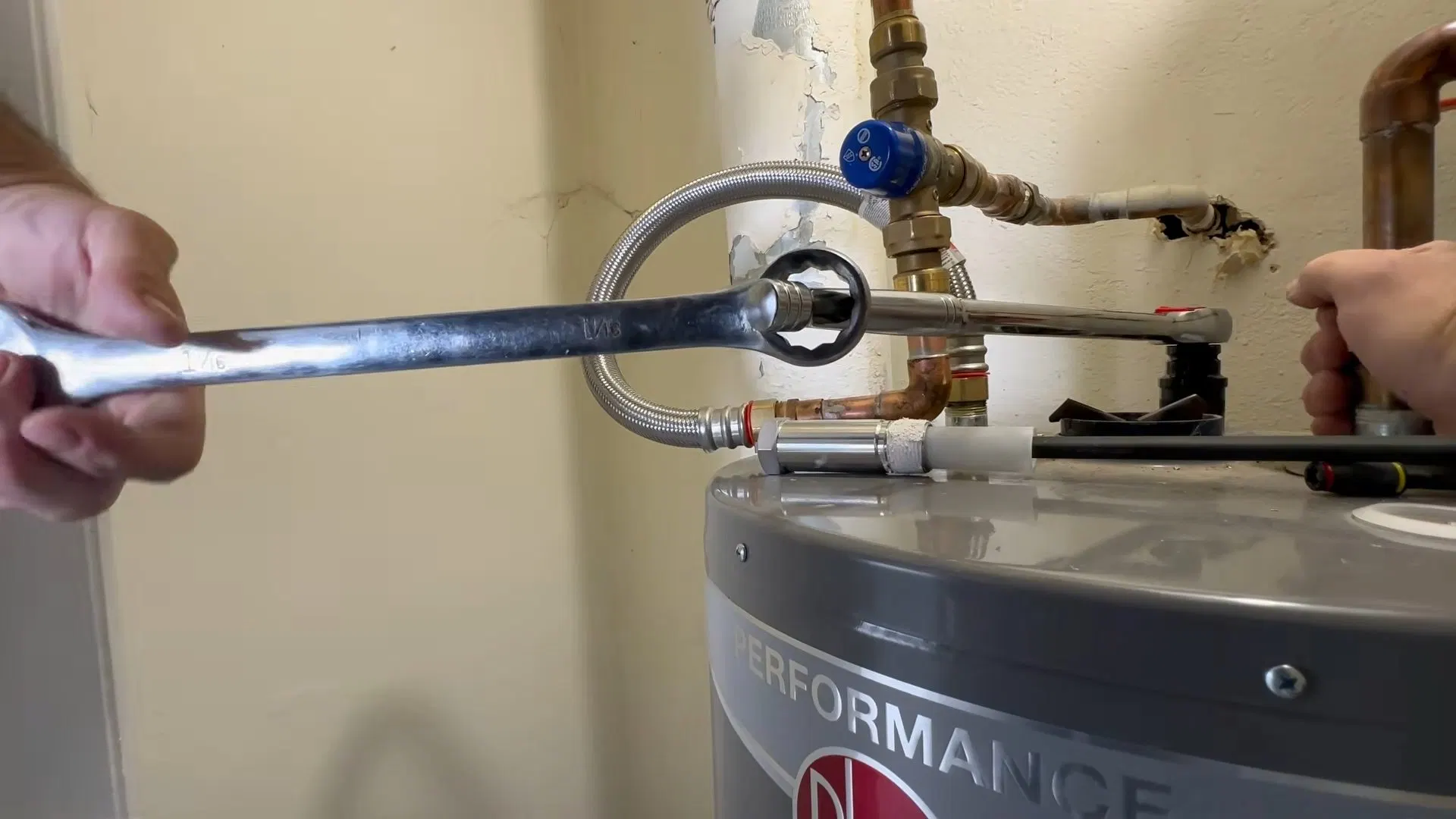 Water Heater Anode Rod Being Loosened shown for Tankless Water Heater in Dallas, GA in Dallas, Georgia.