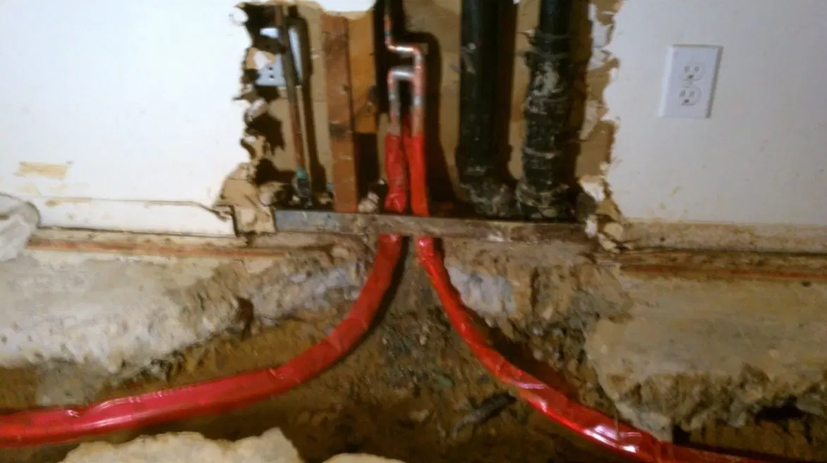 Water Heater Pipes Beneath Open Wall shown for Tankless Water Heater in Dallas, GA in Dallas, Georgia.