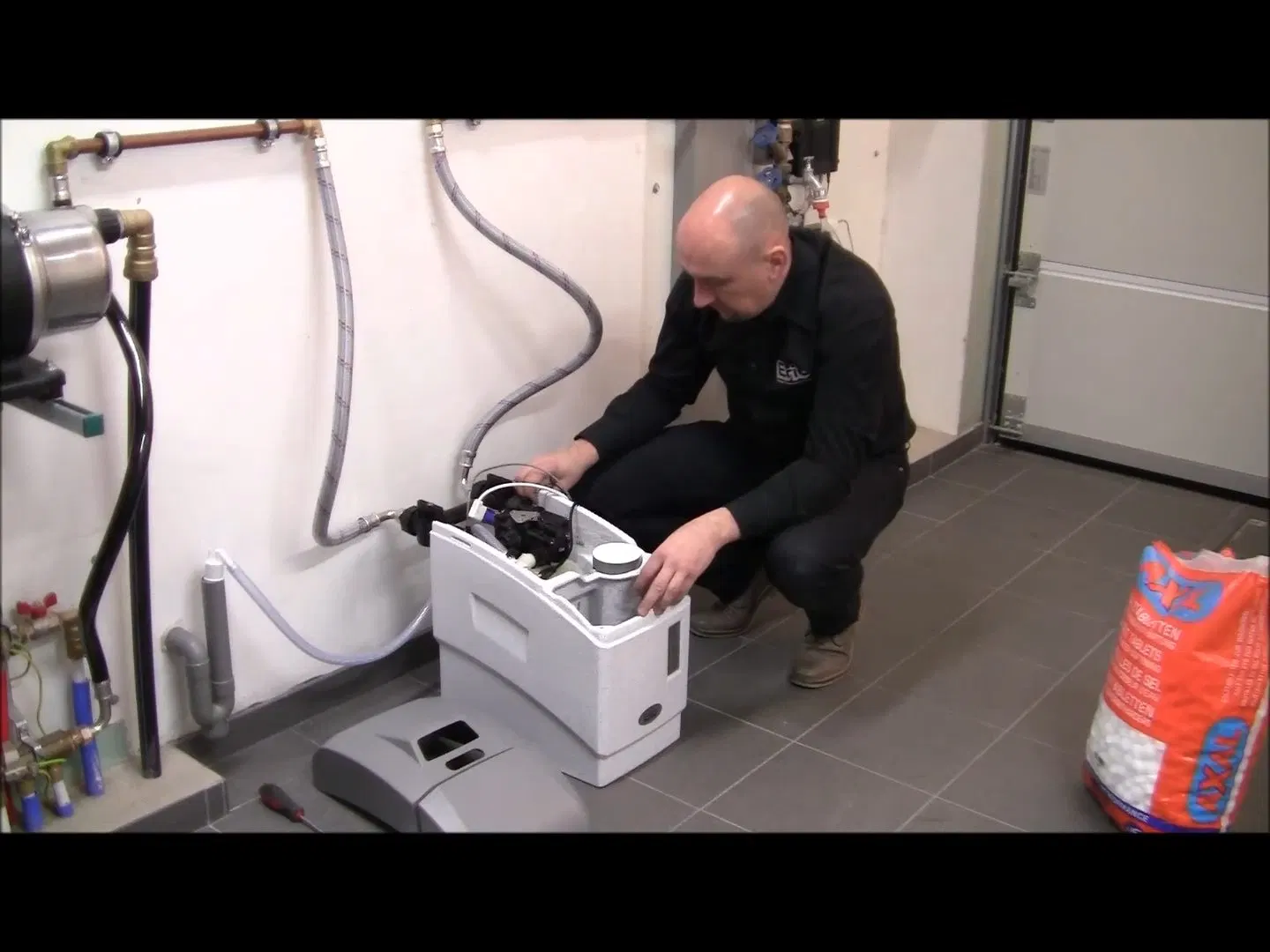 Water Treatment Technician Beside Softener shown for Water Filtration Systems in Dallas, GA in Dallas, Georgia.