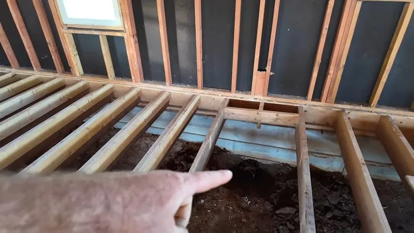 Wood Joists Exposed For Septic Pipe Work shown for Septic Tank Service in Dallas, GA in Dallas, Georgia.