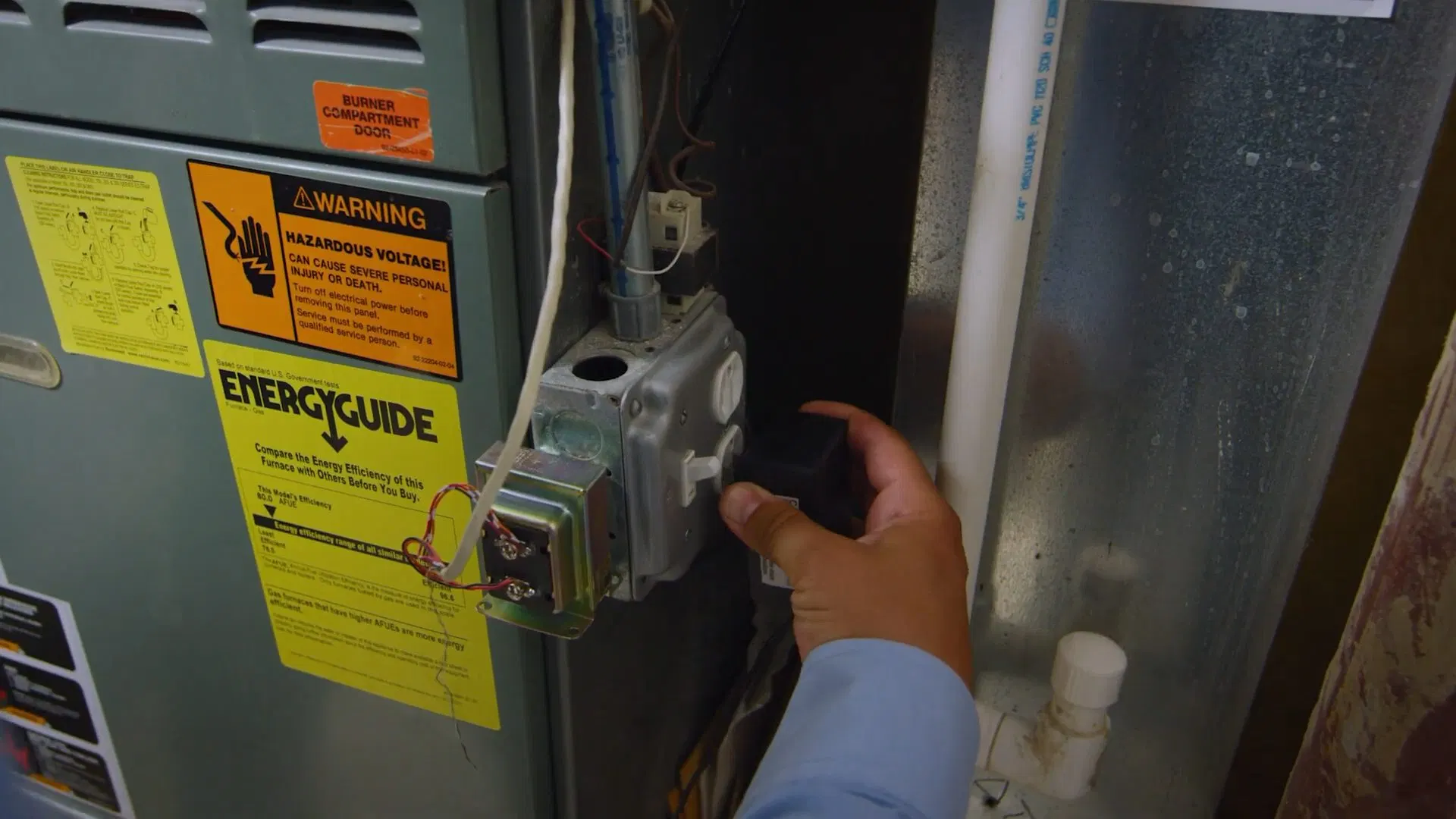 Worker Checking Water Heater Control Panel shown for Gas Line Installation & Repair in Dallas, GA in Dallas, Georgia.