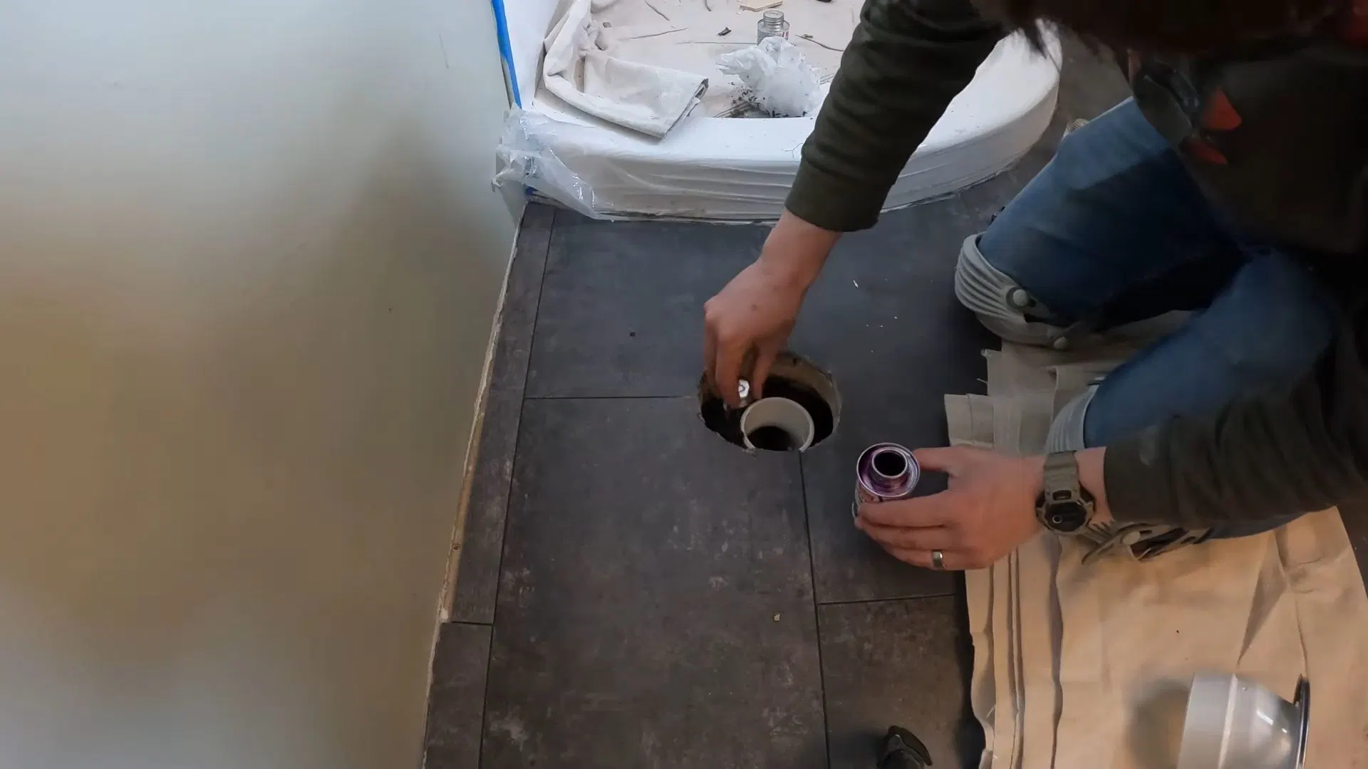 Worker Cutting Bathroom Floor Tile shown for Faucet Repair & Installation in Dallas, GA in Dallas, Georgia.