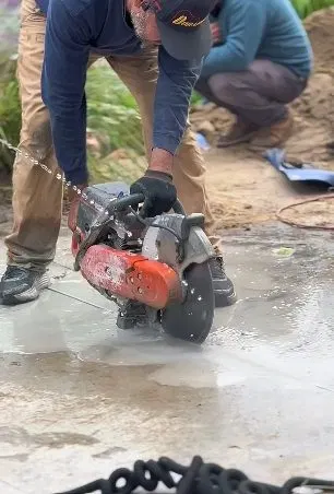 Worker Cutting Slab To Repair Leak shown for Leak Detection in Dallas, GA in Dallas, Georgia.