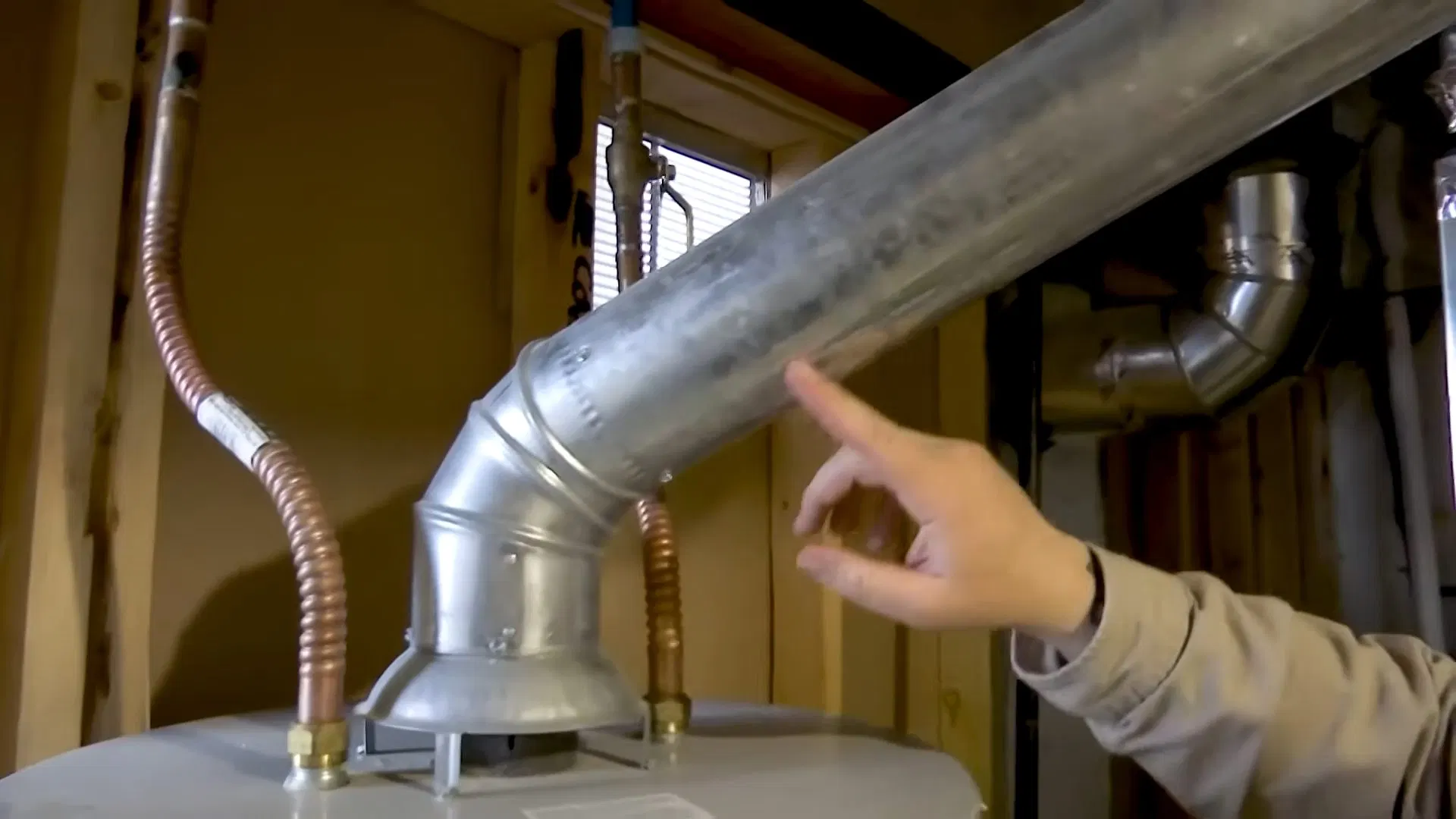 Worker Inspecting Water Heater Vent shown for Gas Line Installation & Repair in Dallas, GA in Dallas, Georgia.