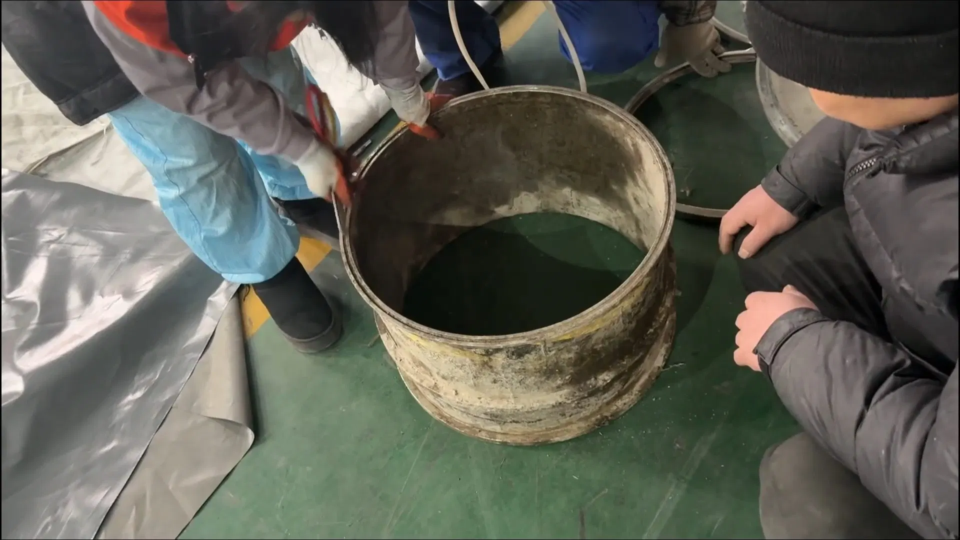 Worker Mixing Sewer Repair Resin In Bucket shown for Septic Tank Service in Dallas, GA in Dallas, Georgia.