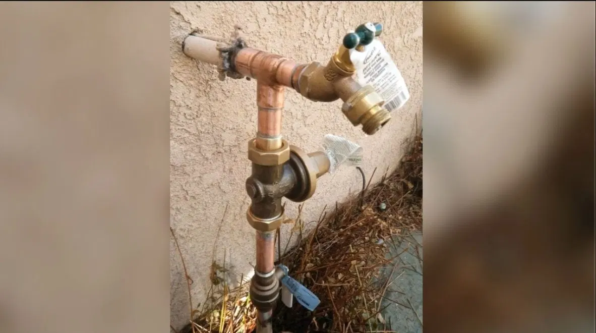 Worker Opening Water Heater Shutoff Valve shown for Gas Line Installation & Repair in Dallas, GA in Dallas, Georgia.
