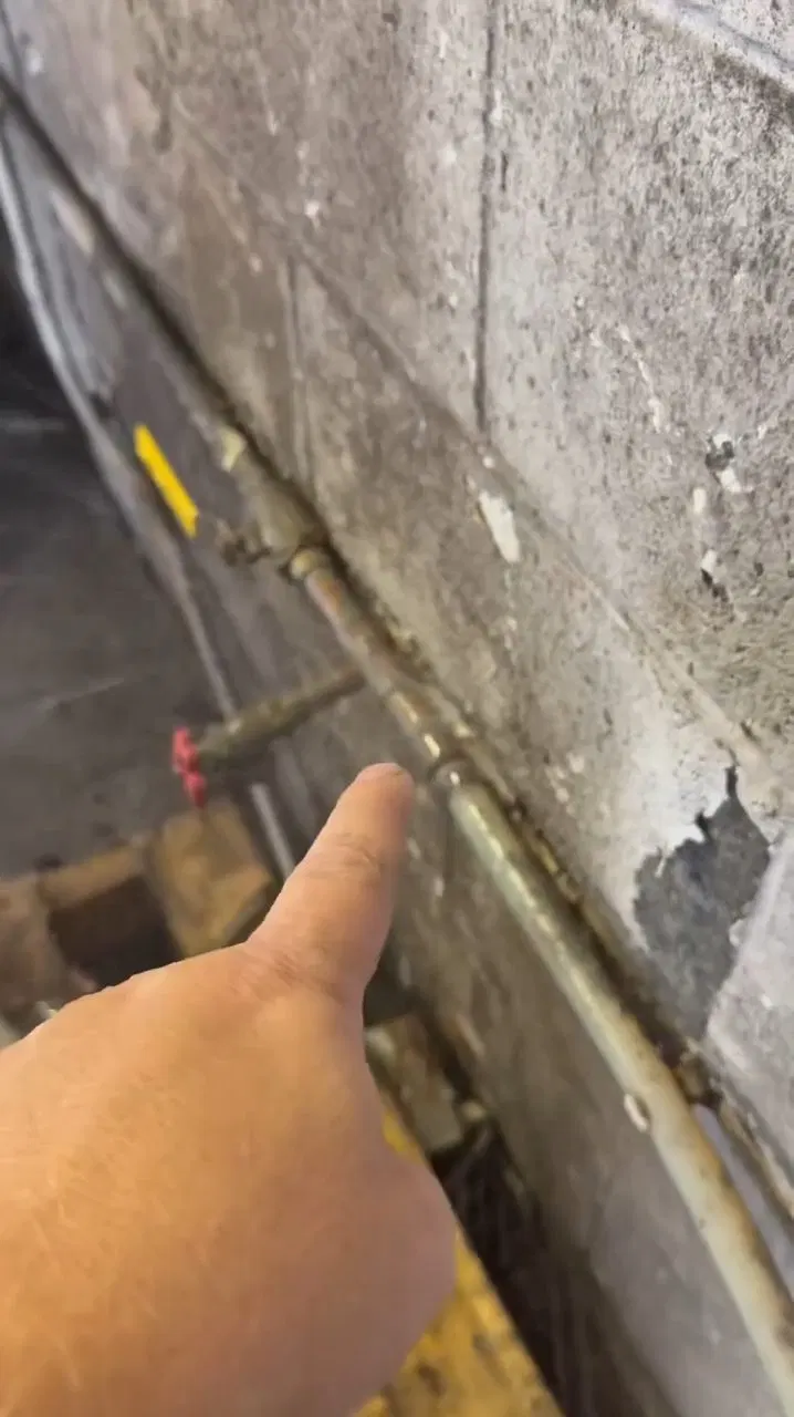 Worker Pointing At Small Copper Pipe Hole shown for Burst & Broken Pipe Repair in Dallas, GA in Dallas, Georgia.